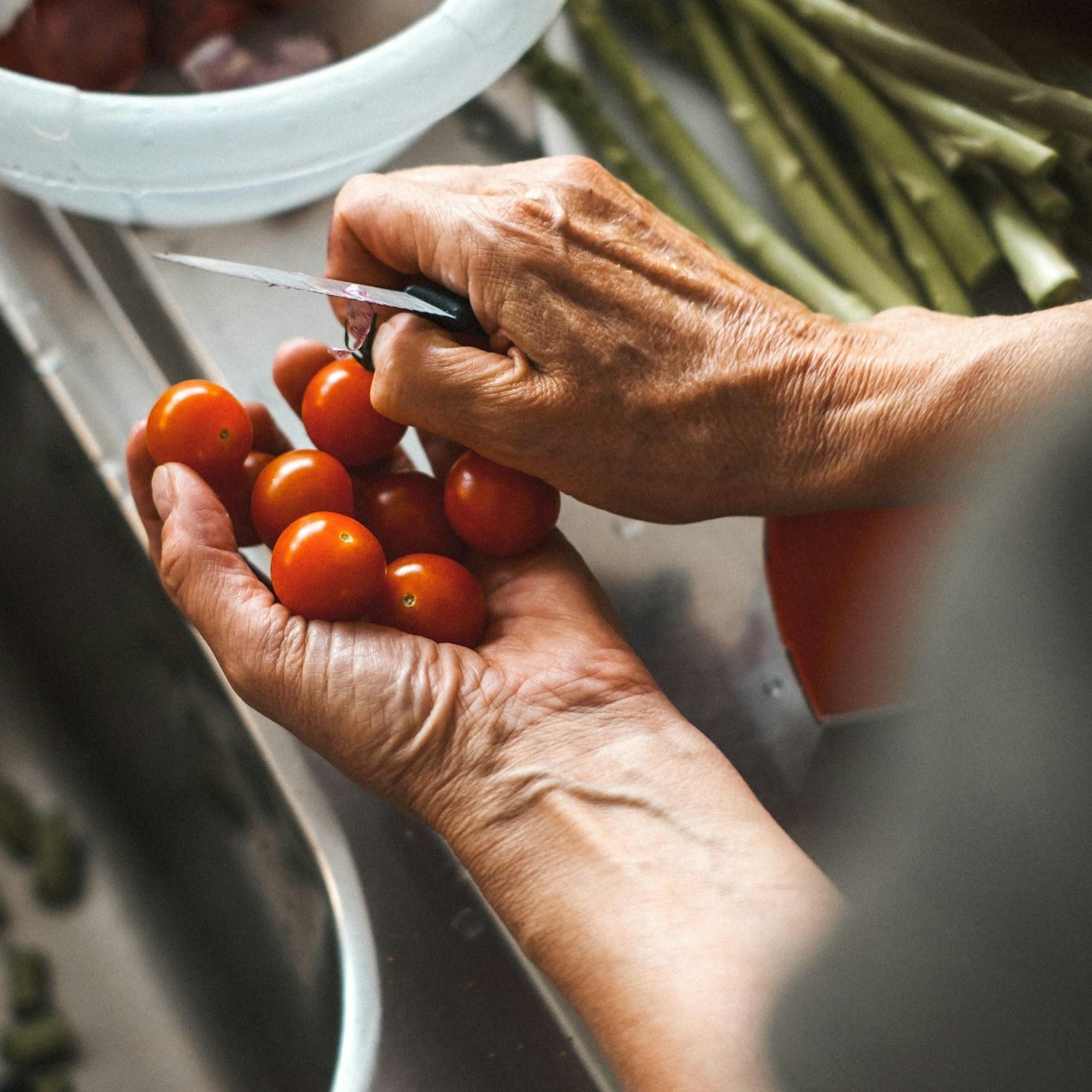 Community members collaborating in a modern kitchen space, sharing recipes and cooking techniques